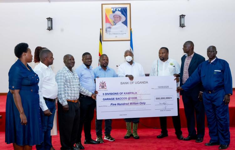 H.E. Y.K Museveni hands over a check to 5 dvisions of Kampala